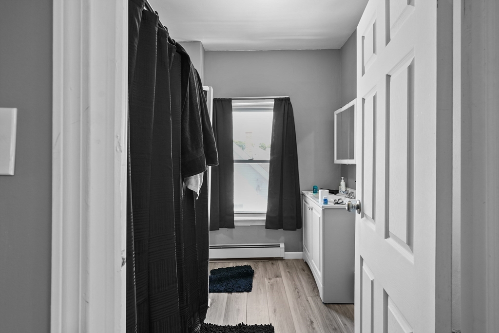 32 Quequechan Street Fall River, MA 02723 - Photo 24 of 34 a view of a hallway with wooden floor and staircase