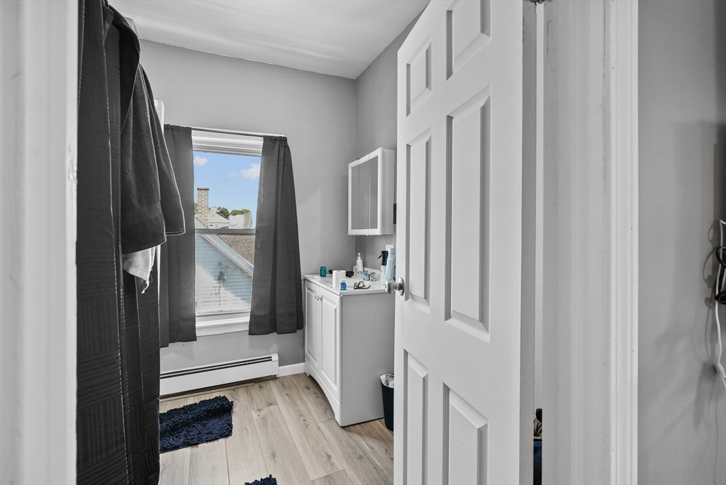 32 Quequechan Street Fall River, MA 02723 - Photo 25 of 34 a view of a hallway with wooden floor and staircase