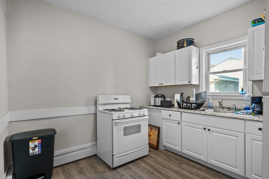 32 Quequechan Street Fall River, MA 02723 - Photo 26 of 34 a kitchen with white cabinets and white appliances