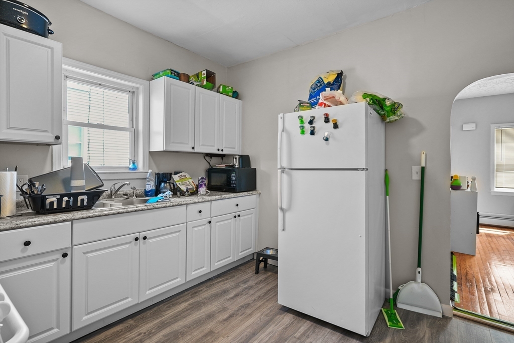 32 Quequechan Street Fall River, MA 02723 - Photo 27 of 34 a white kitchen with refrigerator and a stove
