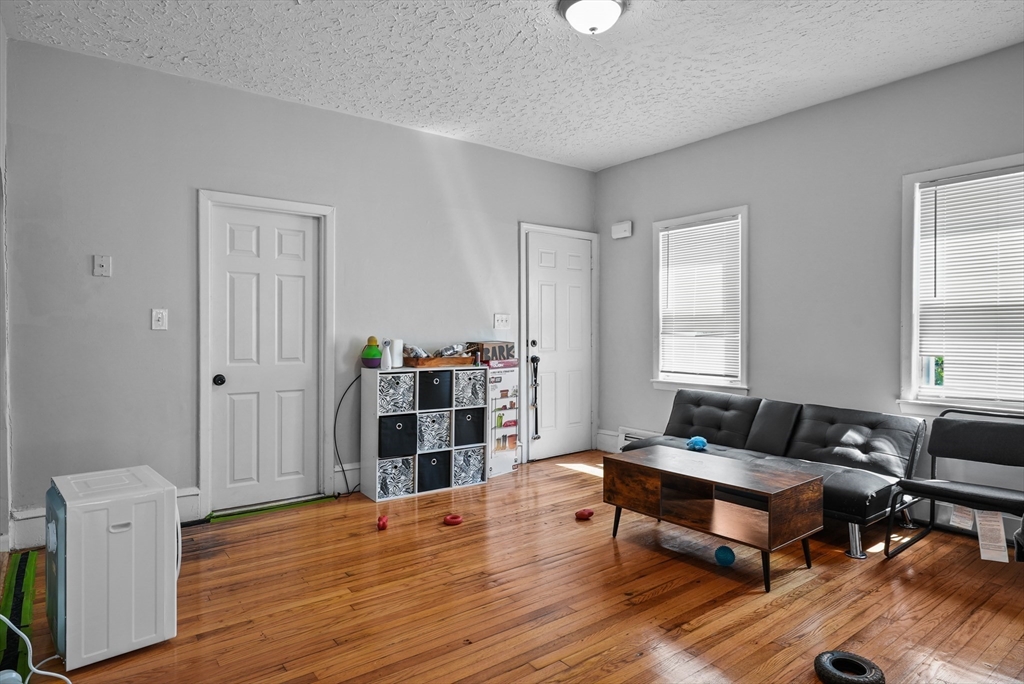 32 Quequechan Street Fall River, MA 02723 - Photo 29 of 34 a living room with furniture and wooden floor