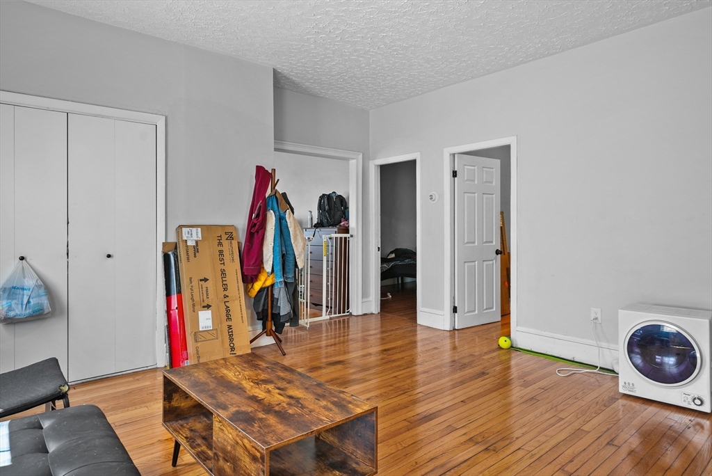 32 Quequechan Street Fall River, MA 02723 - Photo 30 of 34 a view of a room with wooden floor and furniture