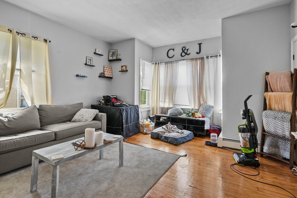 32 Quequechan Street Fall River, MA 02723 - Photo 7 of 34 a living room with furniture and a window