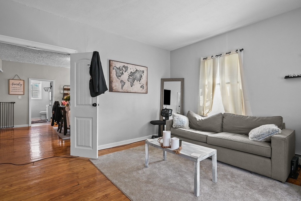 32 Quequechan Street Fall River, MA 02723 - Photo 8 of 34 a living room with furniture and a flat screen tv
