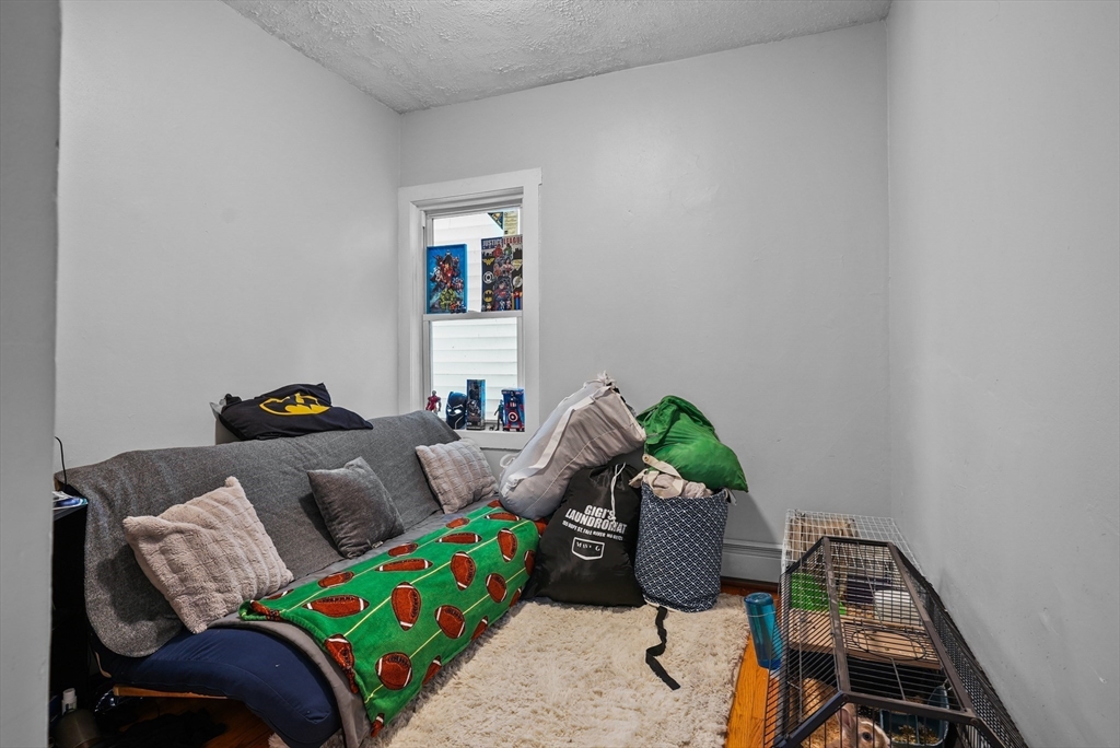 32 Quequechan Street Fall River, MA 02723 - Photo 10 of 34 a living room with furniture and a window