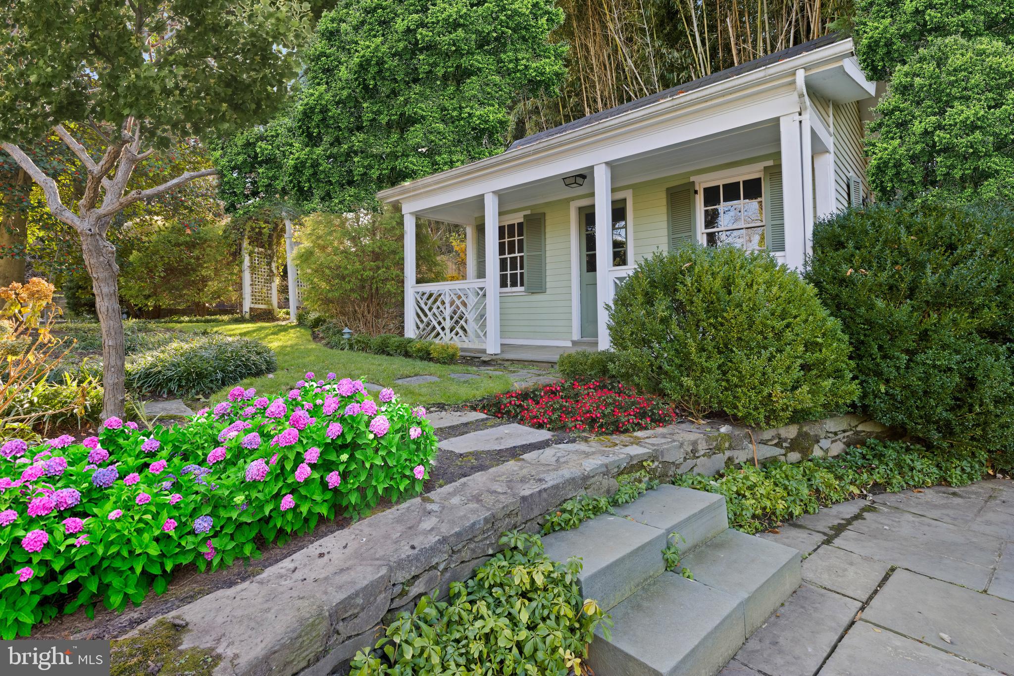7116 Glenbrook Road Bethesda, MD 20814 - Photo 20 of 30 a house with a flower garden in front of it