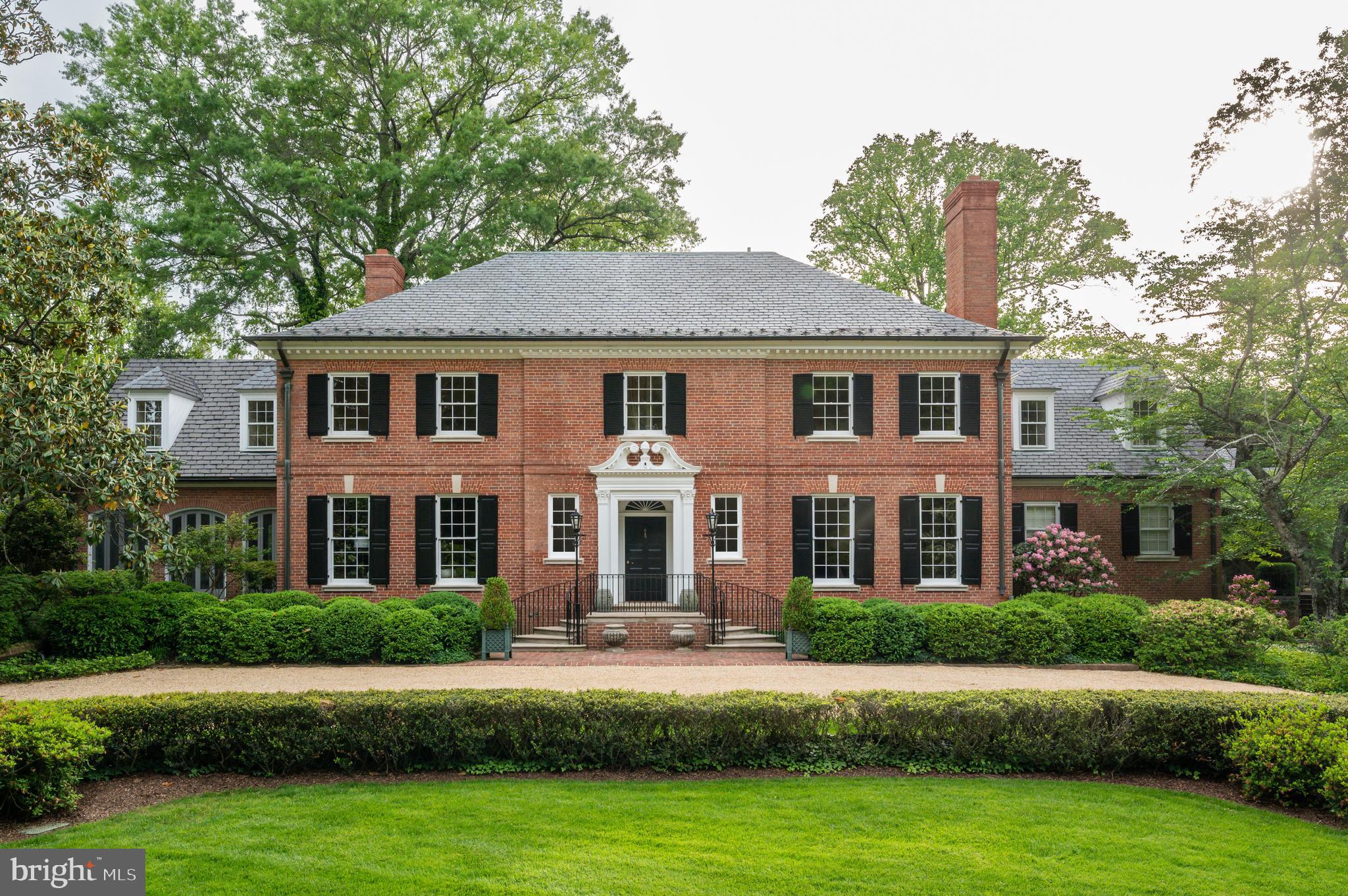 7116 Glenbrook Road Bethesda, MD 20814 - Photo 8 of 30 a front view of a house with a garden