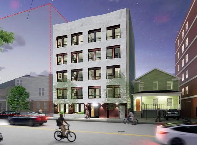 a front view of a building with parked cars