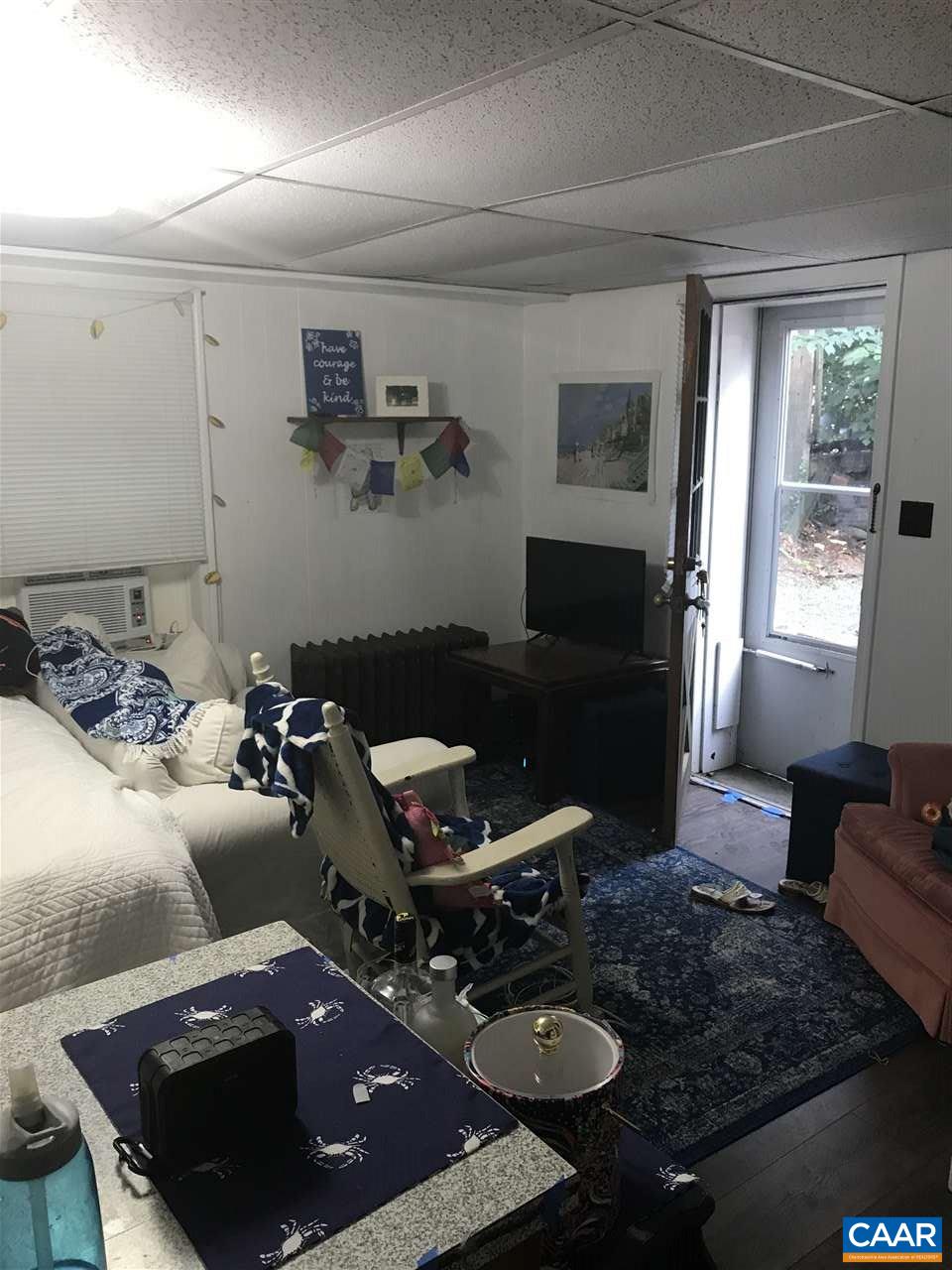 165 Madison Lane, Unit F Charlottesville, VA 22903 - Photo 2 of 3 a living room with furniture and a window