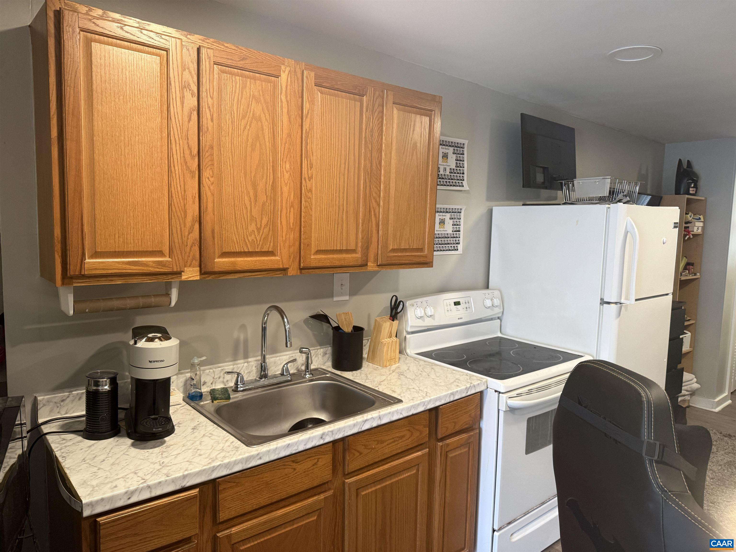 165 Madison Lane, Unit F Charlottesville, VA 22903 - Photo 4 of 9 a kitchen with a refrigerator sink and cabinets