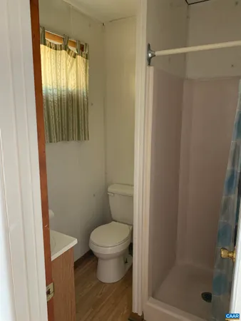 a bathroom with a toilet and a glass door