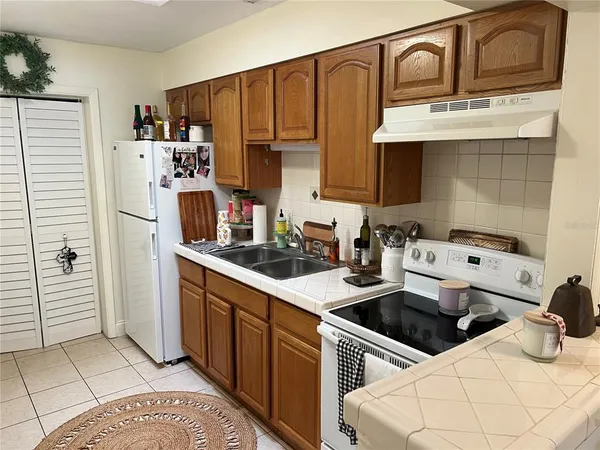 a kitchen with a sink a stove and cabinets