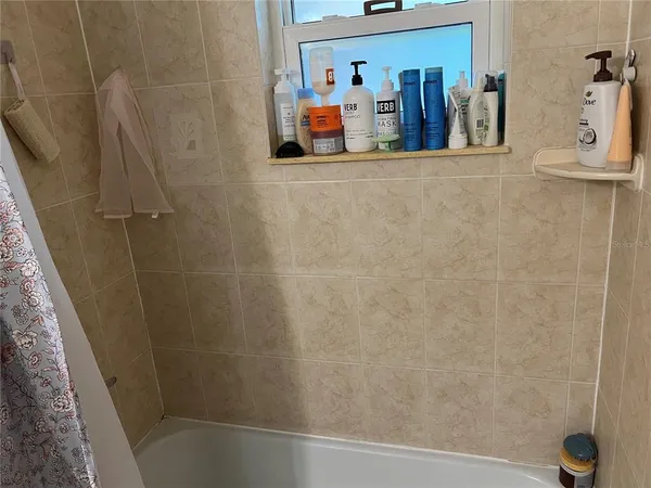 a bathroom with a sink a toilet and shower curtain
