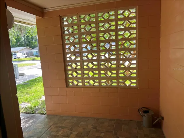 a living room with furniture a rug and gym equipment