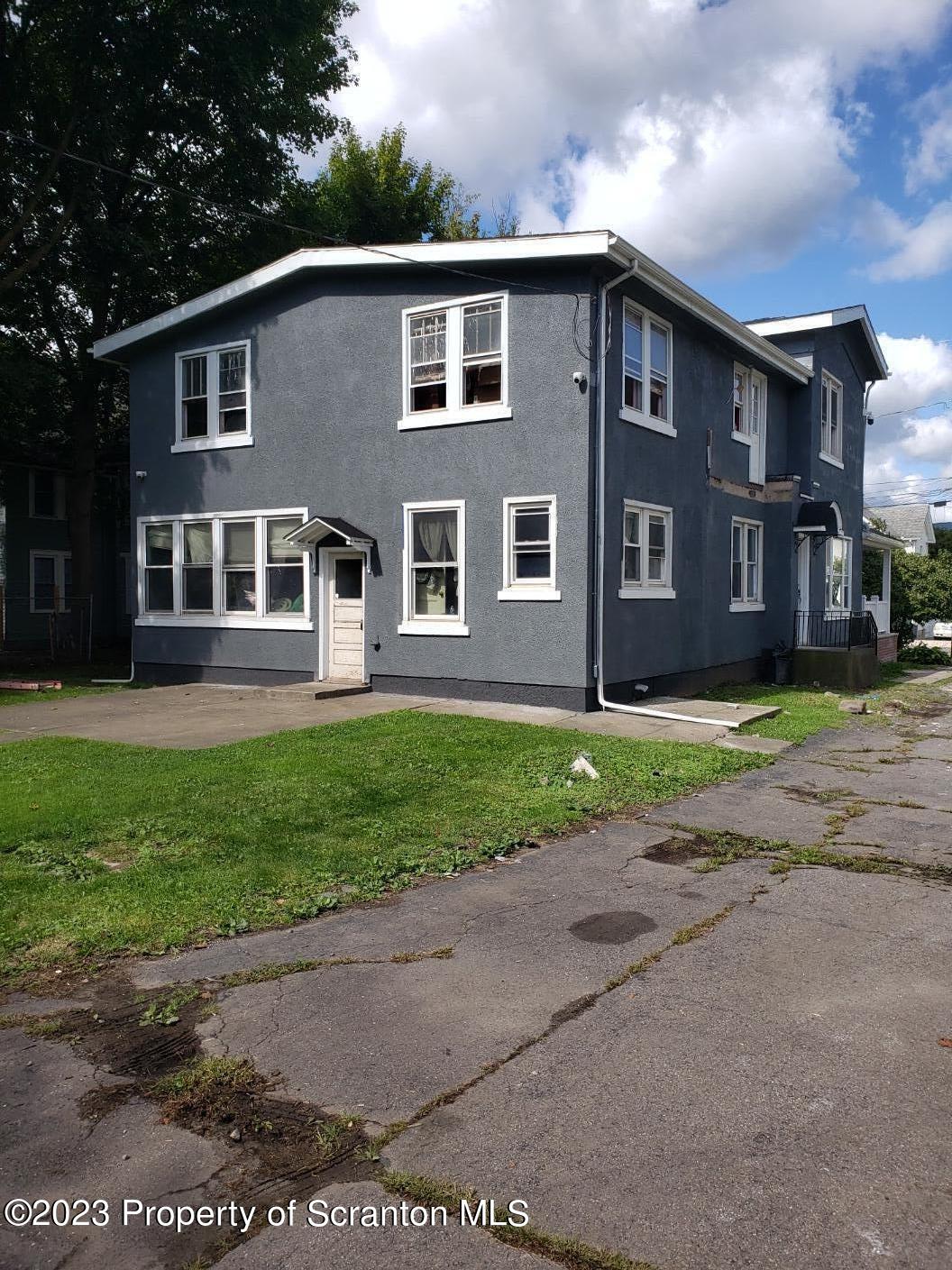 1534 Capouse Avenue, Unit 1 Scranton, PA 18509 - Photo 2 of 7 a front view of a house with a yard