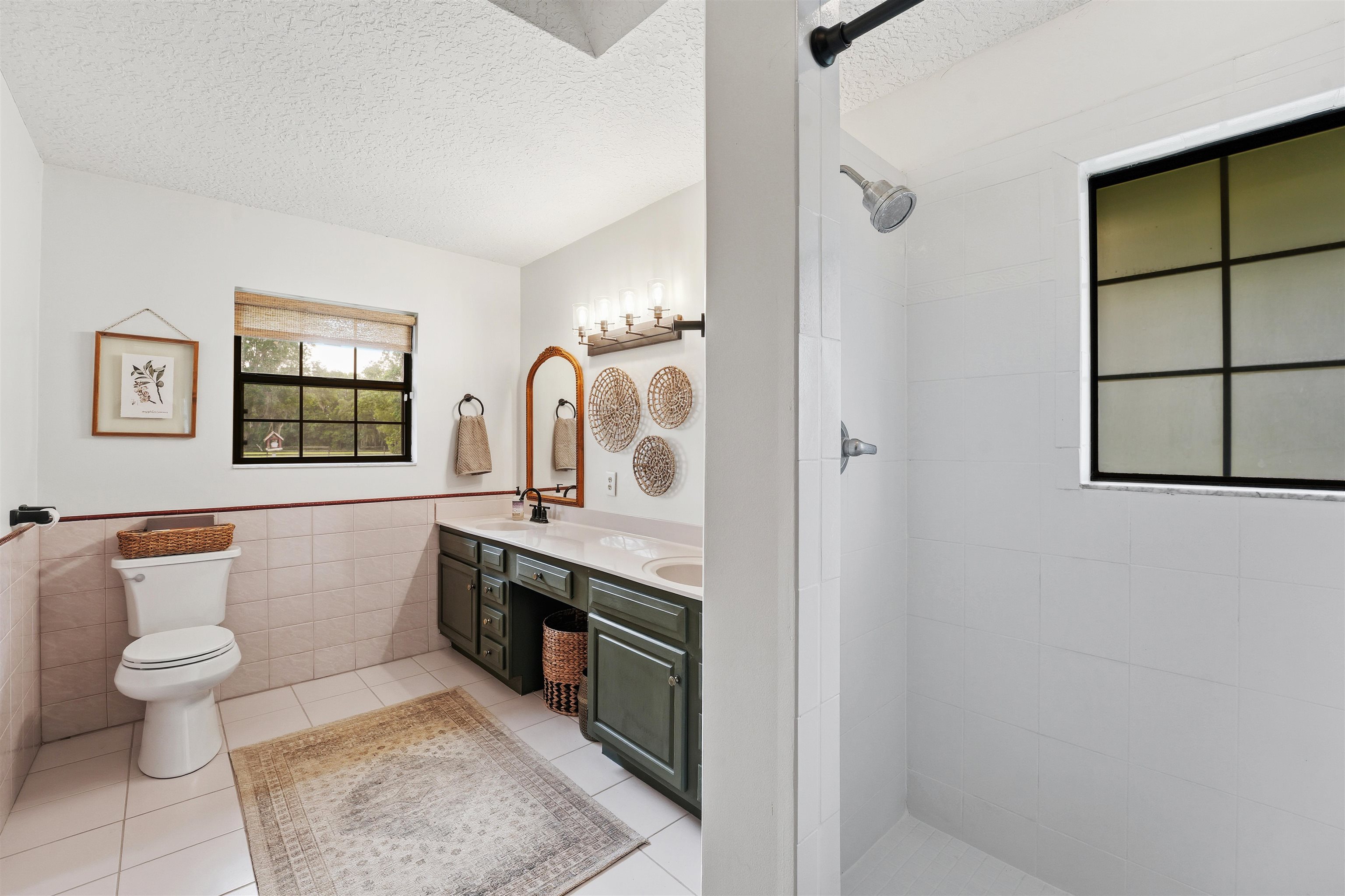 1805 Bennett Road St. Augustine, FL 32092 - Photo 24 of 65 a spacious bathroom with a toilet a sink and a mirror