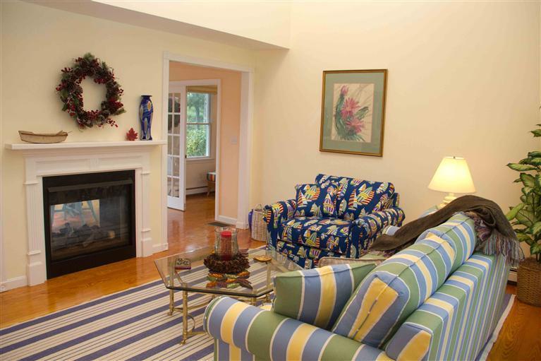 17 Preakness Lane Mashpee, MA 02649 - Photo 5 of 34 a living room with furniture fireplace and painting on the wall