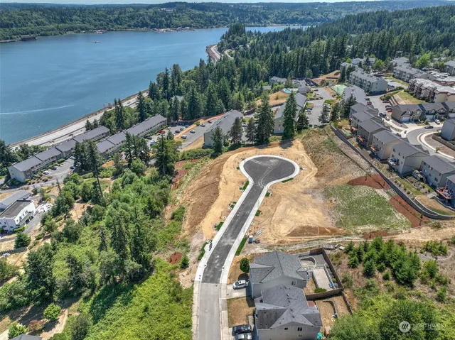 an aerial view of a house with a yard and lake view