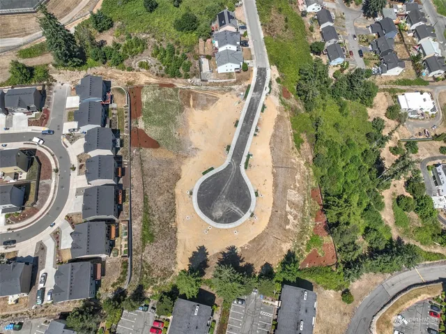 an aerial view of a house with garden space and swimming pool