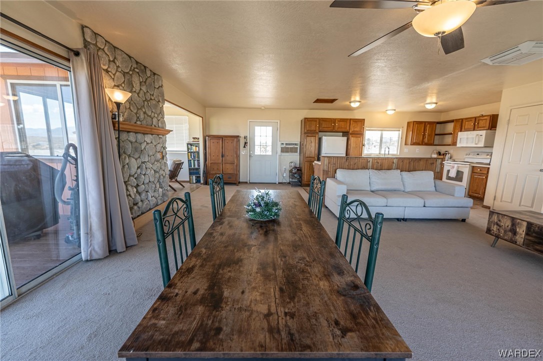 180 Sunfish Way Meadview, AZ 86444 - Photo 11 of 42 a view of a dining room with furniture a chandelier and wooden floor