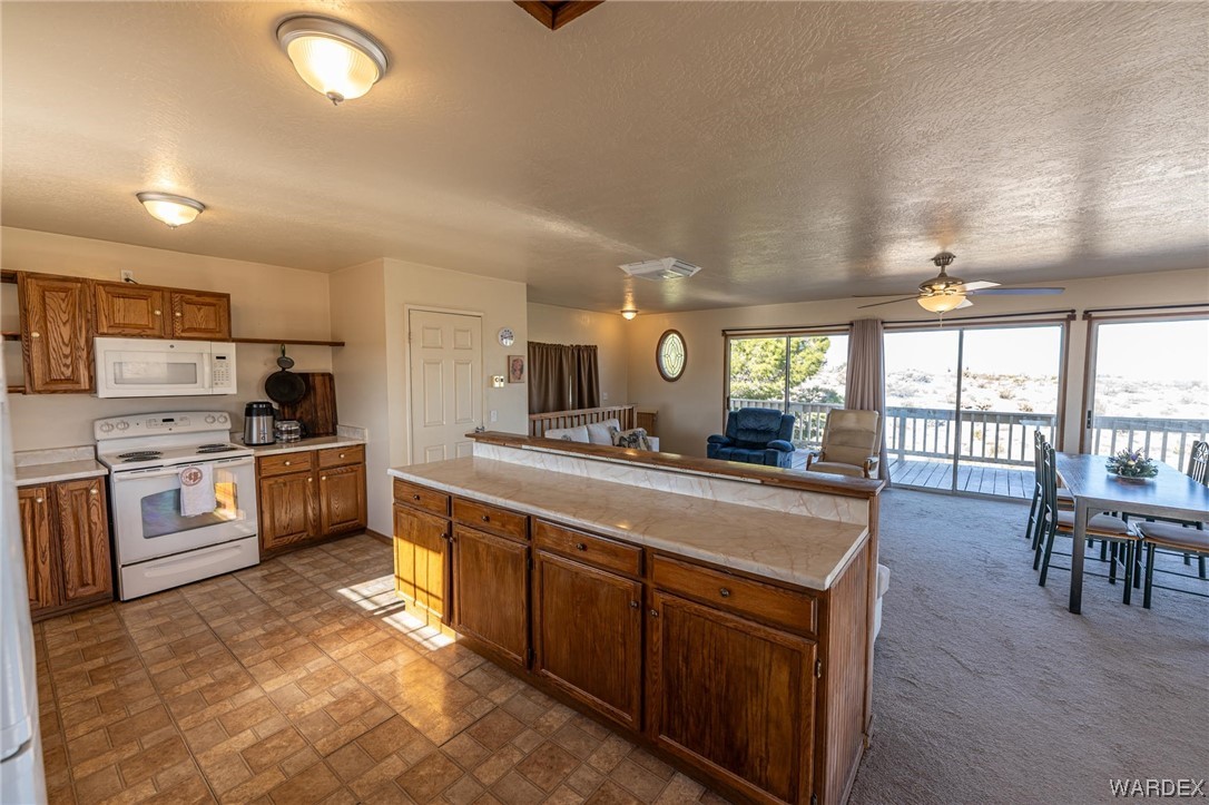 180 Sunfish Way Meadview, AZ 86444 - Photo 14 of 42 a large kitchen with kitchen island a large counter top space a sink a stove and a refrigerator