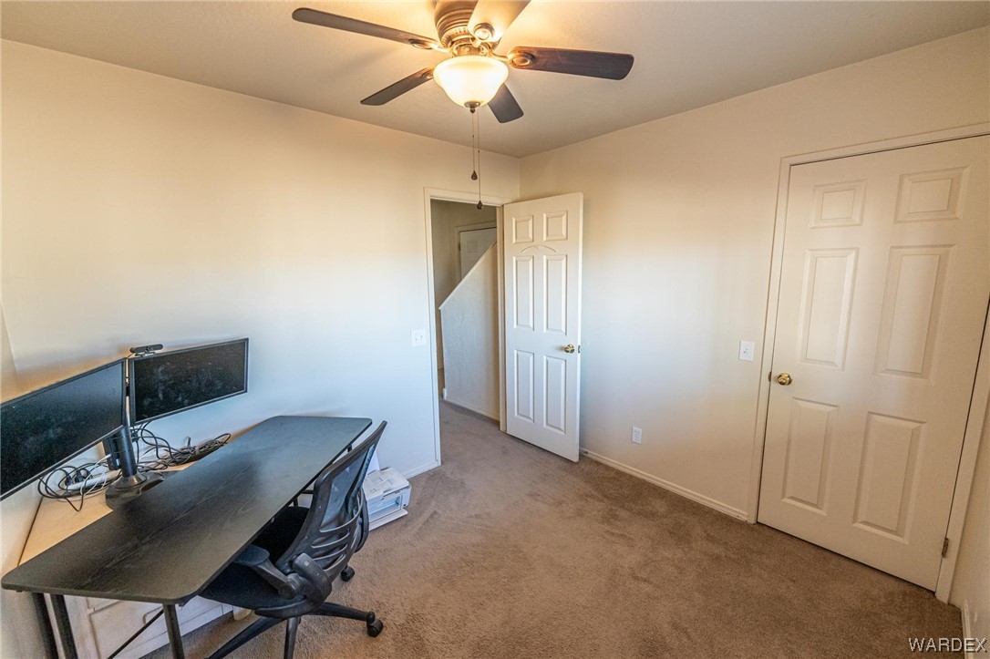180 Sunfish Way Meadview, AZ 86444 - Photo 27 of 42 a workspace with furniture and chandelier fan