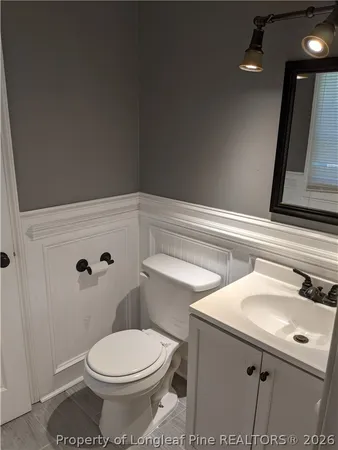 a bathroom with a sink toilet and vanity