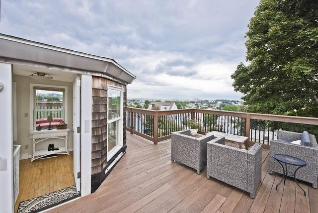 a balcony with furniture and wooden floor