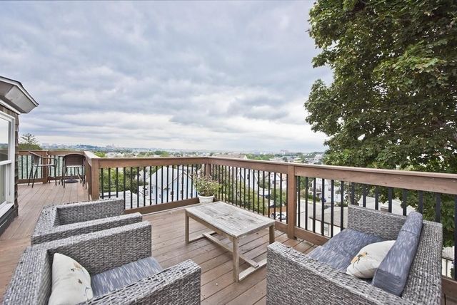 a balcony with furniture and city view