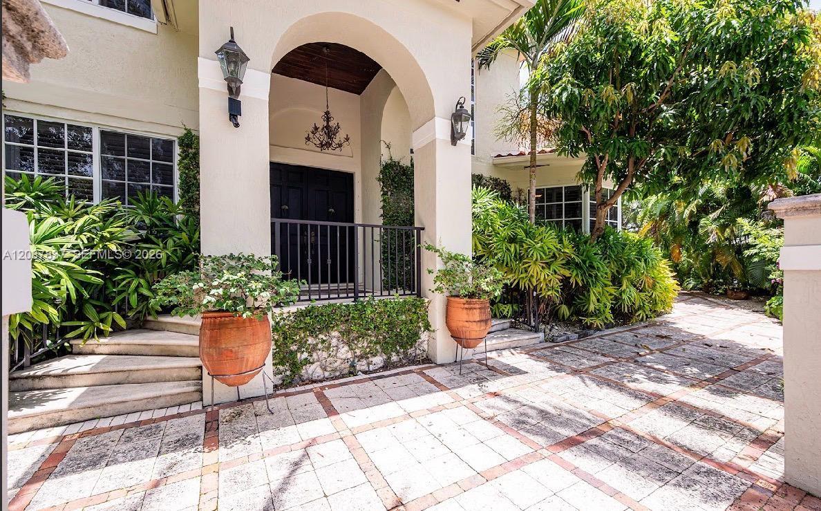 797 Glenridge Road Key Biscayne, FL 33149 - Photo 3 of 39 a front view of a house with a garden