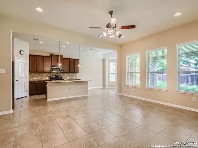 a large kitchen with granite countertop a large counter top stainless steel appliances cabinets and a sink