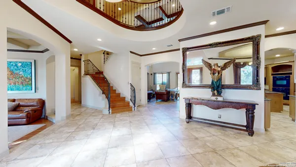 a view of hall way with furniture and entryway