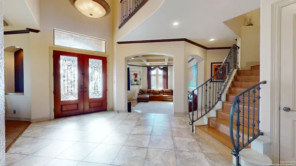 a view of a hallway with entryway livingroom and hall with furniture