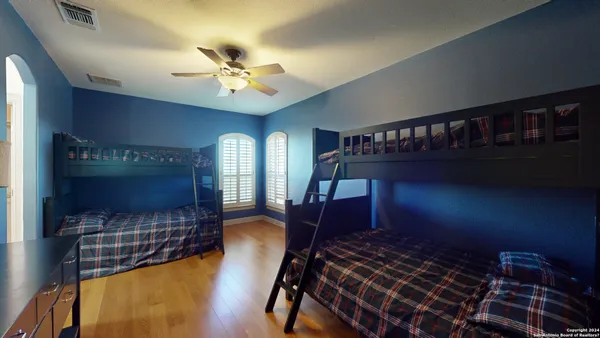 a bedroom with furniture and a chandelier