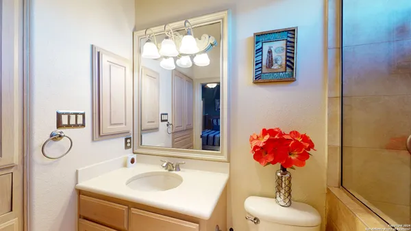 a bathroom with a granite countertop sink and a mirror