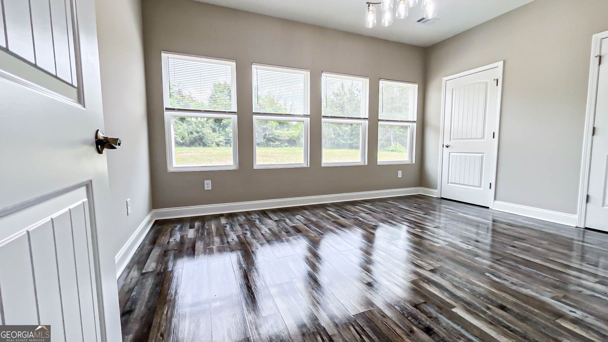 2011 Griffin Road Macon, GA 31216 - Photo 53 of 64 a view of an empty room with wooden floor and a window
