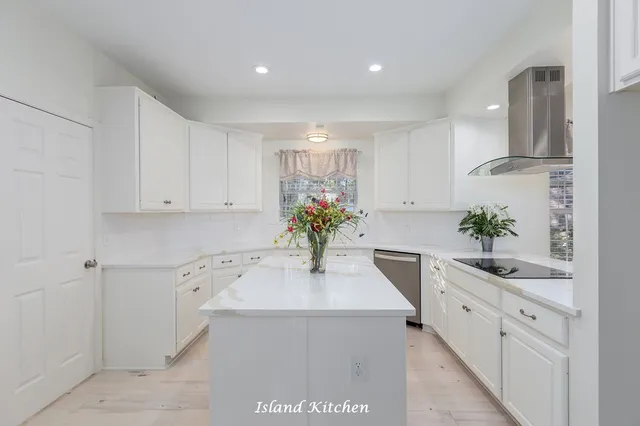 a kitchen with a sink a refrigerator and cabinets