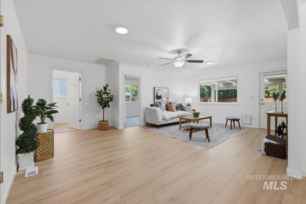 2075 North Springland Place Boise, ID 83713 - Photo 15 of 49 Expansive open-concept living area featuring light wood-finish flooring, recessed lighting, and a ceiling fan