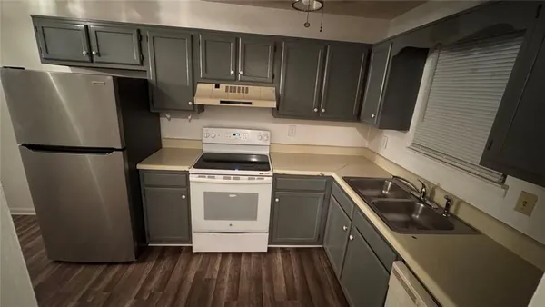 a kitchen with a refrigerator stove and sink