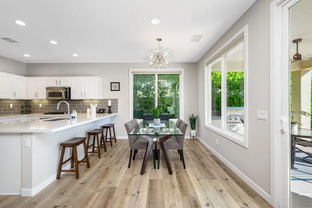 a view of a patio with a table and chairs under an umbrella