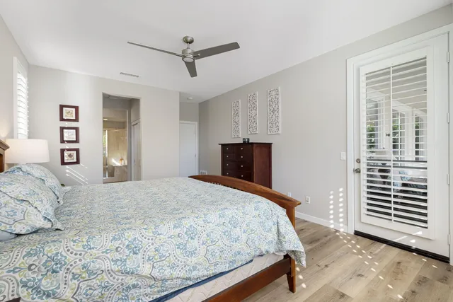 a view of a patio with a table and chairs under an umbrella