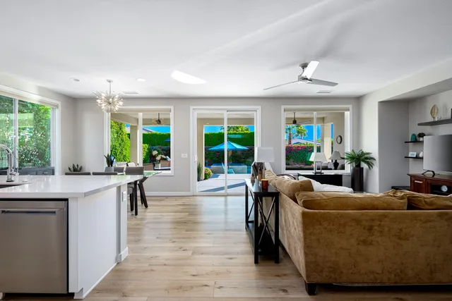 a large white kitchen with a large window