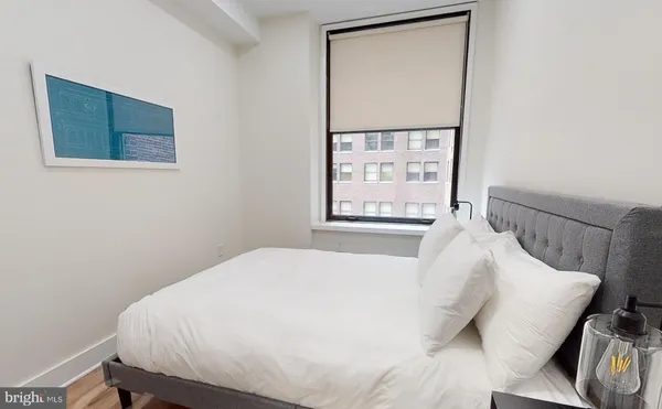 a bedroom with a bed and a window