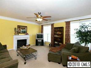 4726 Lapis Court Fort Mill, SC 29708 - Photo 3 of 8 a living room with furniture a fireplace and a flat screen tv