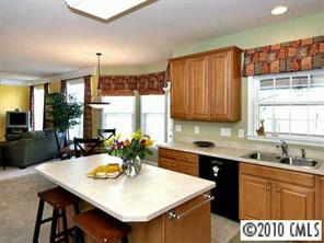 4726 Lapis Court Fort Mill, SC 29708 - Photo 4 of 8 a kitchen with a sink a stove a refrigerator and wooden cabinets