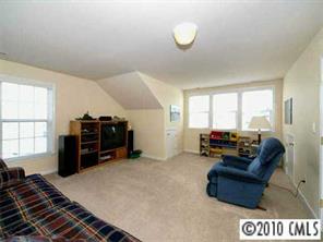 4726 Lapis Court Fort Mill, SC 29708 - Photo 7 of 8 a living room with furniture and a flat screen tv