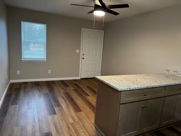 a view of a kitchen counter space and wooden floor