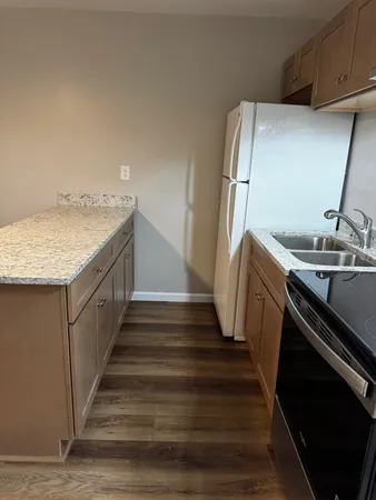 a view of a kitchen with utility room and wooden floor