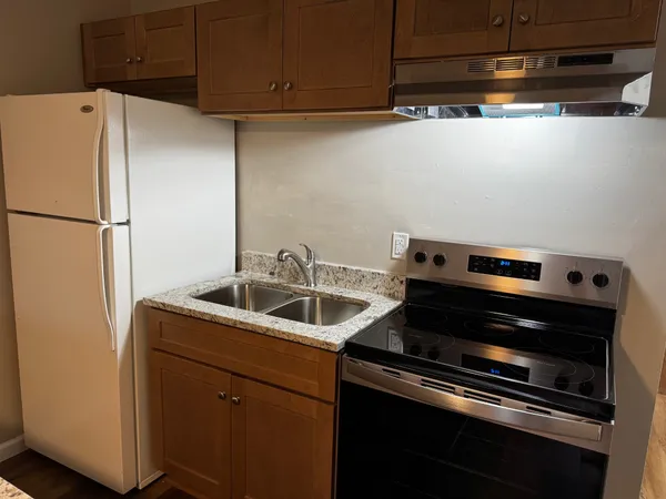 a kitchen with a refrigerator and a sink