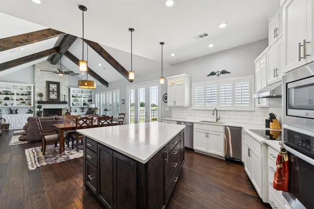 a kitchen with counter top space a sink appliances and cabinets